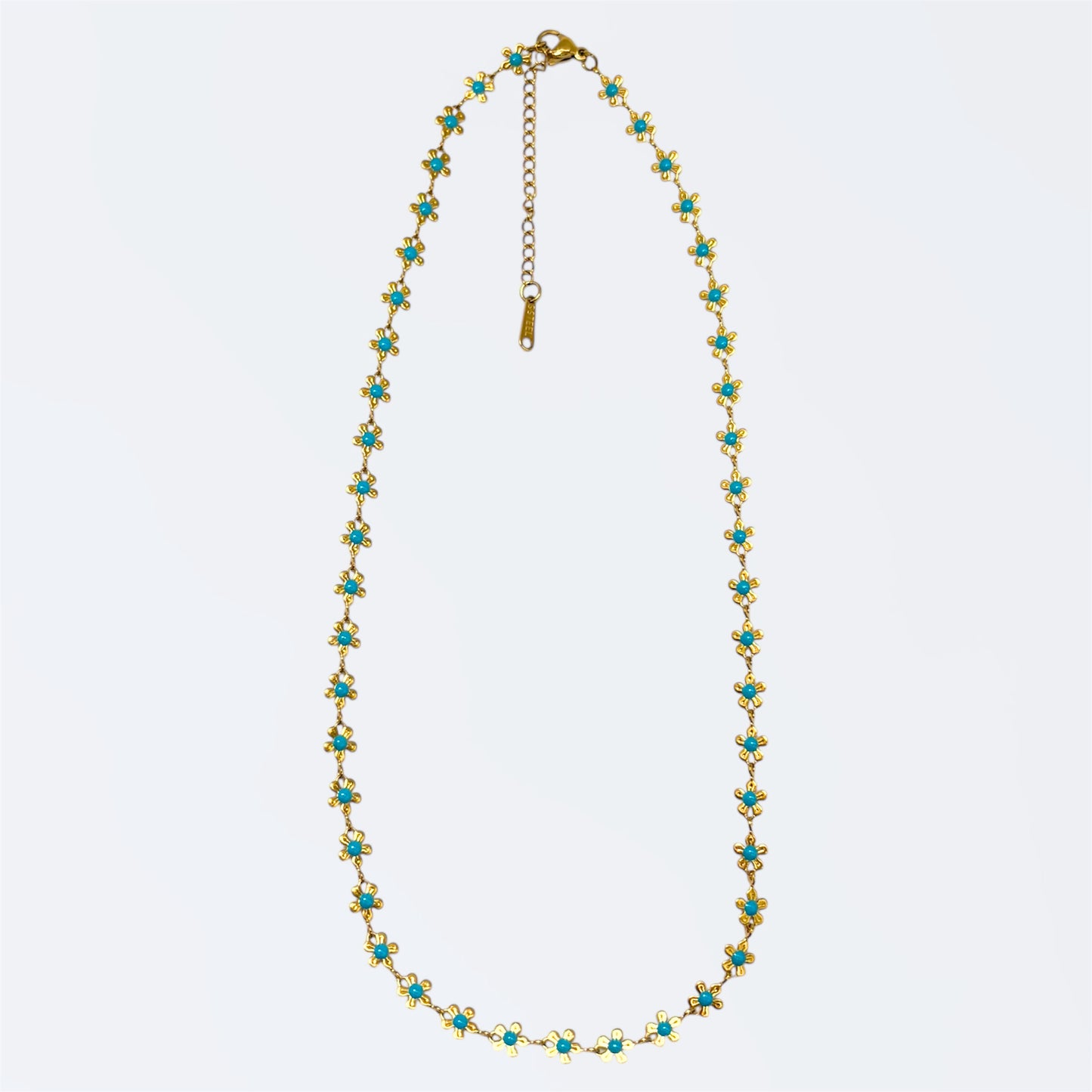 Gargantilla de acero dorado con detalles turquesa