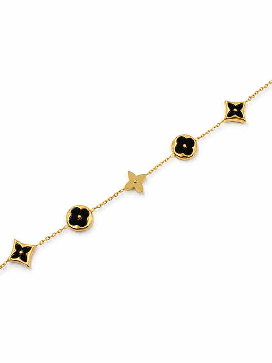 Pulsera con tréboles negro en Acero Dorado